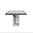 A modern square dining table with a textured gray stone top and a sculptural metallic base, shown against a solid white background.