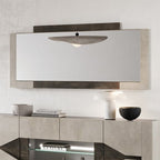 Modern sideboard with decorative mirror and lamps in a room setting.