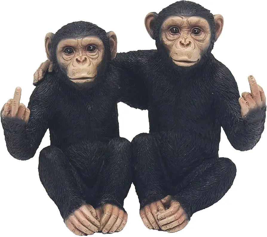 Two realistic chimpanzee figurines sitting side by side on a plain white background, each holding up an obscene middle-finger gesture.