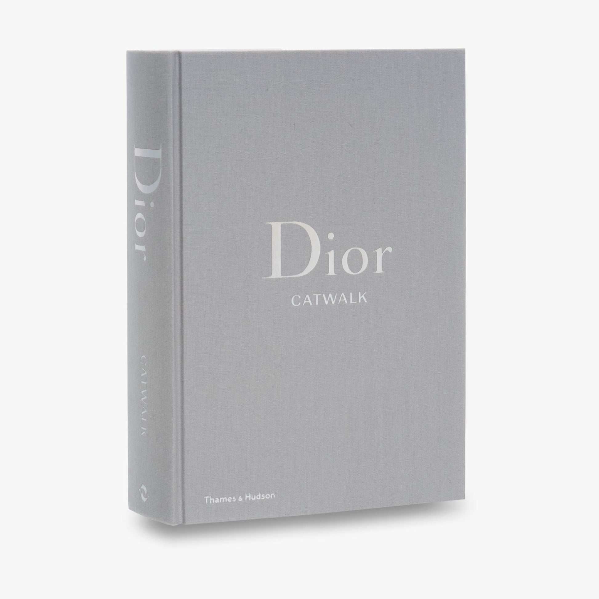 Gray book titled 'Dior Catwalk' on a white background