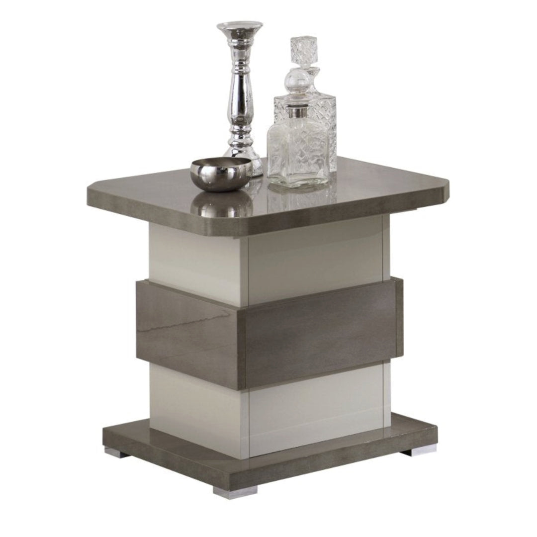 Modern side table with decorative items on a white background