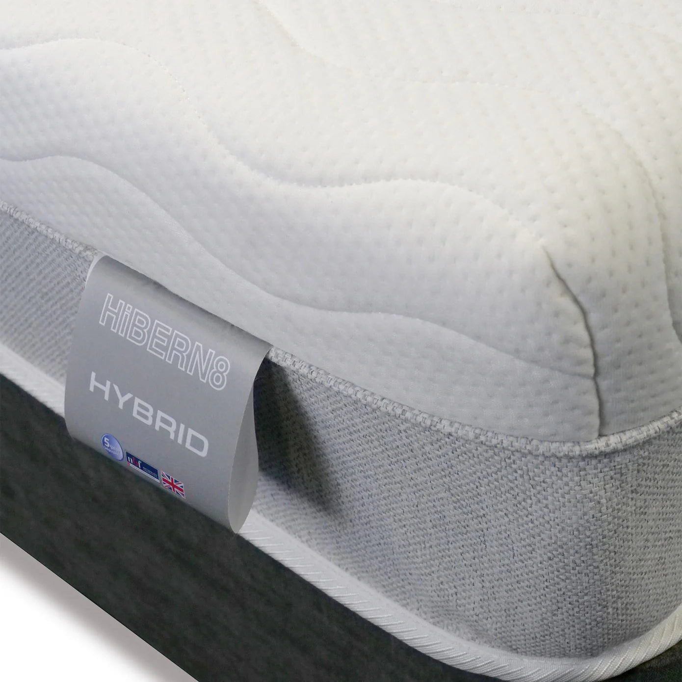 Close-up of a Hibern8 Hybrid mattress with branding visible.
