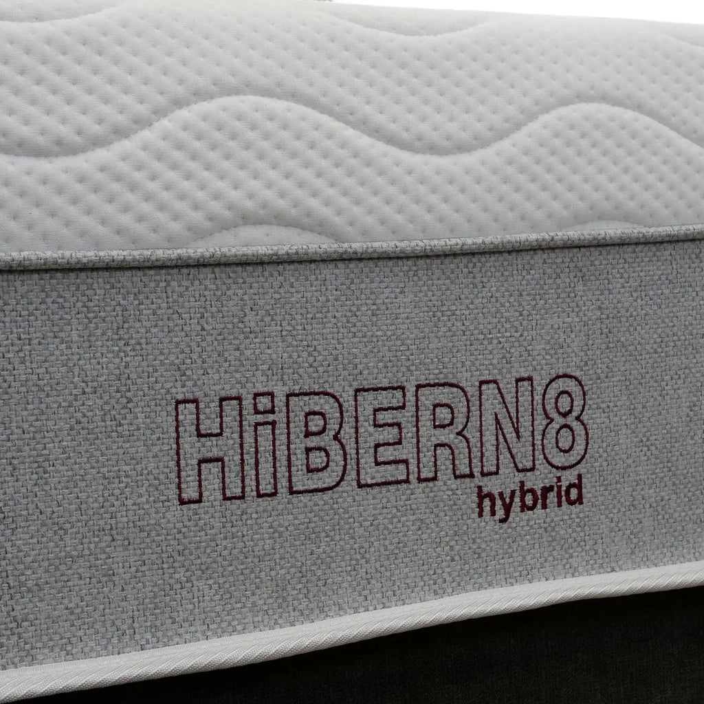Gray mattress with 'Hibern8 hybrid' branding on a black background