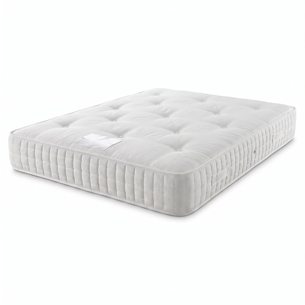 A white tufted mattress shown at an angle on a clean white background.