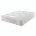 A white tufted mattress shown at an angle on a clean white background.
