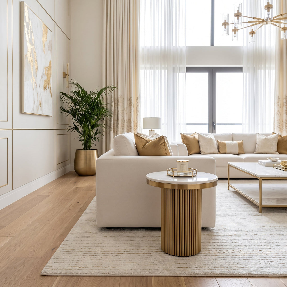 Cassa white marble side table styled in front of a cream sofa